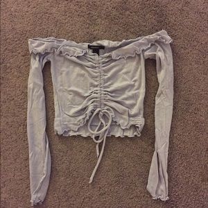 Long sleeve cropped off the shoulder